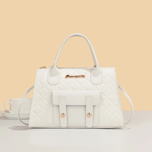 Close-up of white quilted leather bag with elegant gold hardware and checkered texture