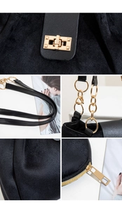Detail view of black velvet tote bag with gold metal hardware and ring chain straps