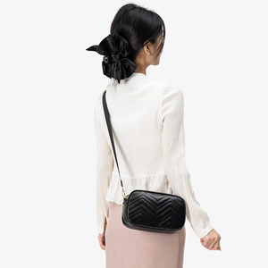 Chic black chevron quilted square crossbody bag with gold hardware and adjustable strap