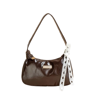 Dark brown glossy PU leather underarm bag with a white lace bow heart decoration