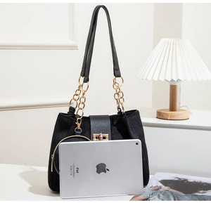 Interior view showing black suede tote capacity with iPad and small round pouch accessory