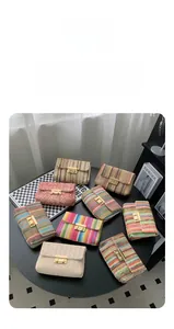 Variety of colorful woven crossbody bags with gold metal clasps in a stylish collection