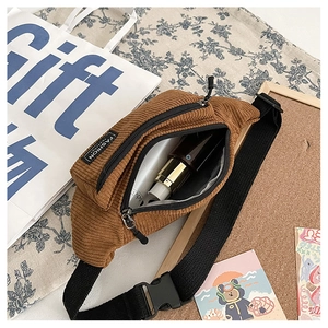Detail of corduroy waist bag interior showing storage capacity and velvet texture