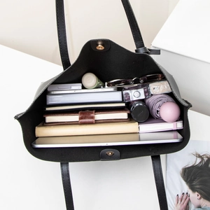 Large black soft leather tote bag with ample interior space for laptop and daily essentials