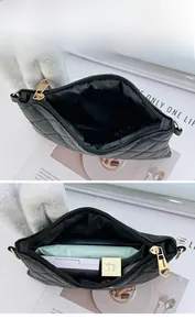 Detail view of the spacious black quilted PU leather crossbody bag with items inside