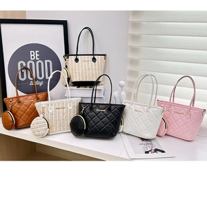 Detail view of woven bucket bag set with quilted leather textures and round charm coin purse