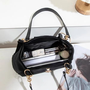 Large black suede tote bag with gold chain showing spacious interior for tablet and notepad