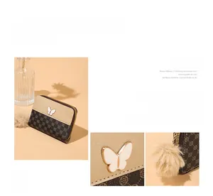 Detail of compact zip wallet with lattice pattern, butterfly logo, and pompom charm