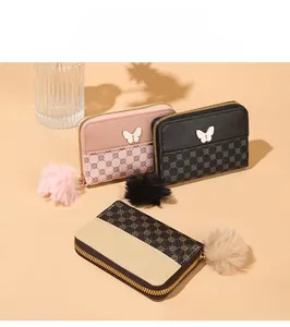 Detailed view of color-block wallets with vintage circle patterns and butterfly buckles