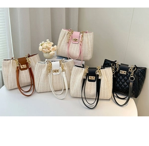 Detail view of woven and quilted tote bags with metal chain straps and twist locks