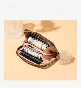 Detail of vintage printed coin purse with pink interior slots and plush butterfly charm