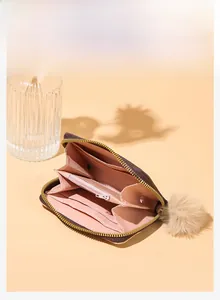 Brown litchi grain wallet with pink lining, multi-card slots and plush pompom charm