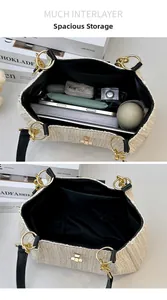 Detailed view of spacious bucket bag interior with multiple compartments for daily items