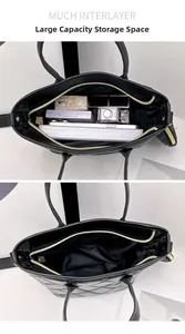 Detail showing high-capacity interior with multi-compartments in a black quilted tote bag