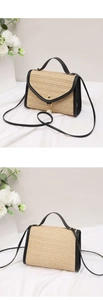 Detailed view of woven straw crossbody bag featuring black leather trim and pearl pendant