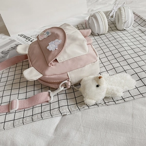 Cute pink and beige crossbody bag with bunny ears, bear plush pendant and adjustable strap