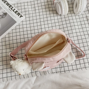 Pink cartoon bunny ear crossbody bag for girls with plush bear charm and adjustable strap