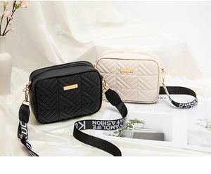 Detail of quilted crossbody bags in black and beige with metallic logo and fashion strap