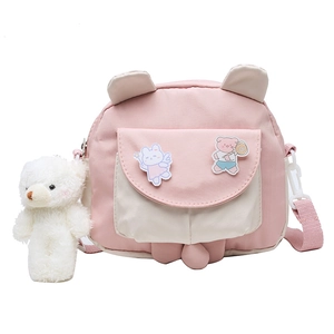 Cute pink and white crossbody bag for girls with cartoon patches and plush bear charm