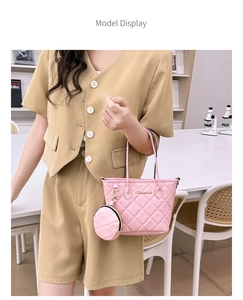 Pink quilted tote bag with mini coin purse detail shown on a chic fashion model