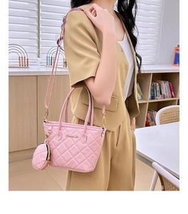 Detail of light pink quilted tote bag with matching round pouch and gold metal logo