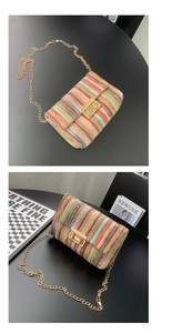 Detailed macro view of colorful woven handbag featuring a gold chain and metal twist lock