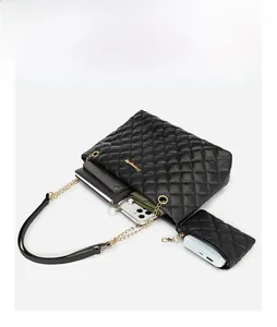Quilted tote bag capacity view showing phone and notebook with a small coin purse