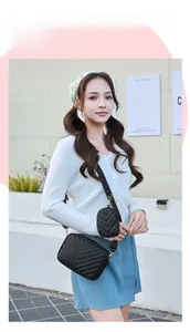Detail of black V-quilted crossbody bag with matching mini pouch and gold hardware
