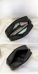 Detailed view of the black crossbody bag interior with gold zipper and ample storage