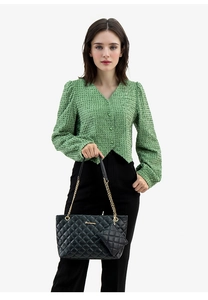 Close-up of black quilted tote bag set with chain strap and matching mini pouch