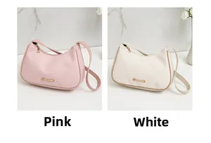 Detail view of pink and white faux leather hobo bags with lychee grain texture
