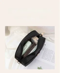 Detailed interior of the quilted camera bag showing layered storage and golden zippers