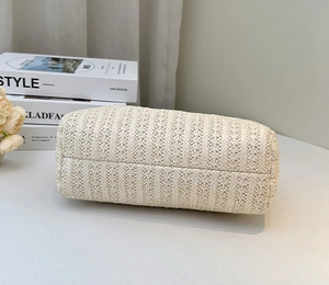 Close-up of woven beige tote bag base showing intricate arrow pattern craftsmanship