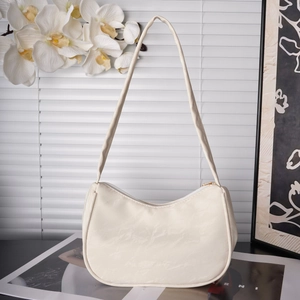 Close-up of ivory pleated hobo bag with gold zipper and minimalist floral background