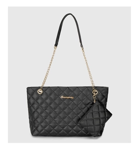 Close-up of black quilted tote bag with golden metal logo and mini coin purse attachment