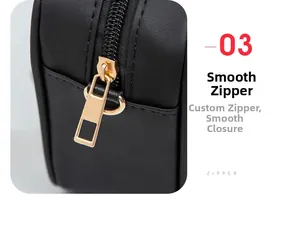 Detailed macro view of smooth golden metal zipper on black leather shoulder bag