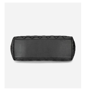 Detailed bottom view of black quilted leather tote bag with precise stitching