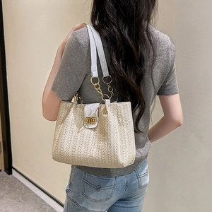 Large straw bucket tote bag with white leather straps and golden clasp for women