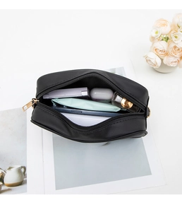 Interior view of black nylon organizer bag showing phone and cosmetics storage capacity