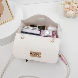 Chic quilted crossbody bag in beige with gold lock and floral scarf detail showing interior