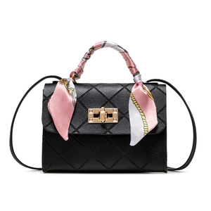 Classic black quilted crossbody bag with golden turn-lock and silk scarf handle detail