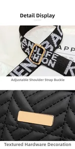 Detail of black quilted camera bag showing adjustable wide strap and gold hardware