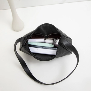 Minimalist black lychee pattern underarm bag with spacious interior for daily essentials
