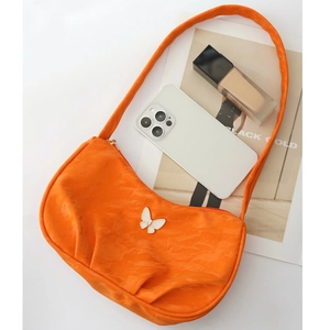 Bright orange patent leather shoulder bag with butterfly metal buckle and zipper closure