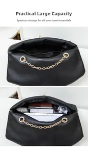 Detail view of the spacious black crossbody bag interior holding a tablet and cosmetics