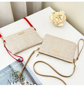 Detailed view of woven straw handbags with golden hardware and leather straps