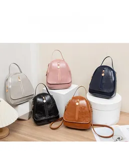Multi-color display of textured PU leather mini backpacks with golden zippers and accents