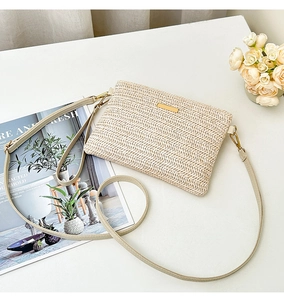Detailed close-up of beige woven texture bag with gold clasp and leather strap