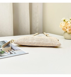 Detailed macro view of cream woven crossbody bag texture with premium leather strap