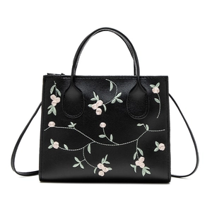 Black leather handbag with floral embroidery and detachable shoulder strap in a main view